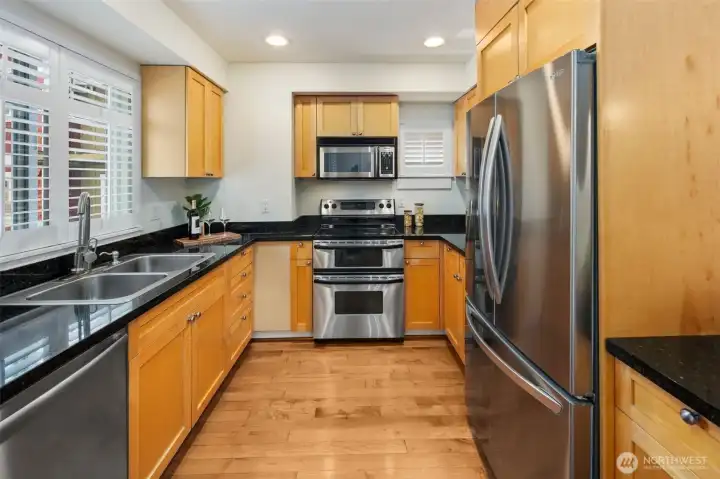 Upgraded kitchen provides plenty of storage alongside beautiful stainless steel appliances.