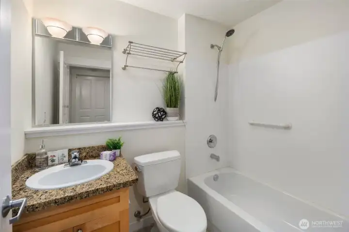 The home's lower level features a two car garage, full bath, and bedroom.