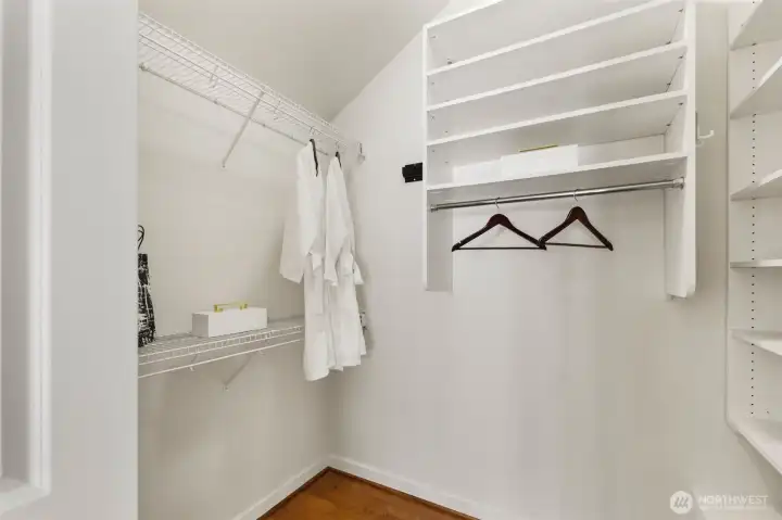 Massive walk in closet with custom closet system.