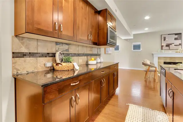 Gleaming granite slab countertops and an abundance of beautiful cabinetry wraps around the kitchen, for maximum use of space.