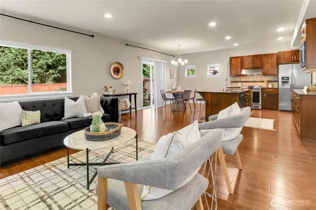 In the kitchen dining area an oversized window overlooks the fully fenced backyard, and two smaller windows overlook the side yard.