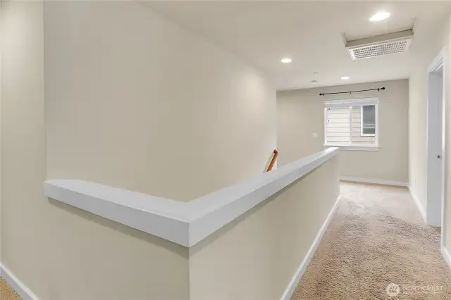 In addition to the primary bedroom, there are three additional bedrooms on the upper level.