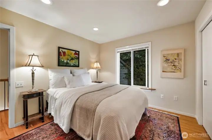 Second bedroom on upper level, large closet and hardwood flooring.