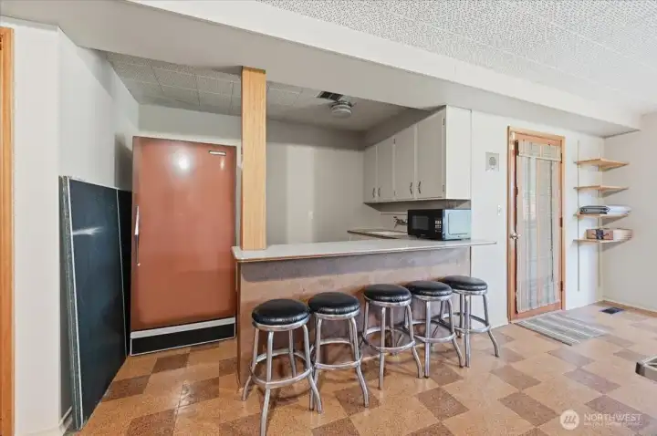 Kitchenette and door to patio and yard.