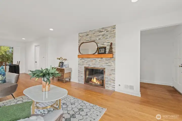 Updated ledger stone gas fireplace with oak mantle