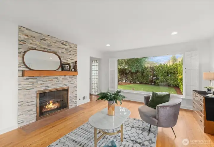 Oversized front window looking out onto front yard, with private mature hedges from the street.