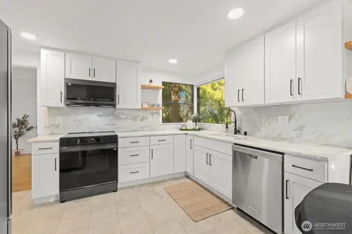 Updated kitchen with all brand new appliances, quartzite countertops, laminate flooring and custom cabinetry.