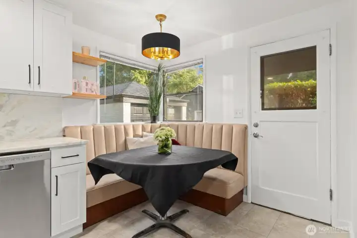 built-in banquet with new lighting fixture and access to the exterior