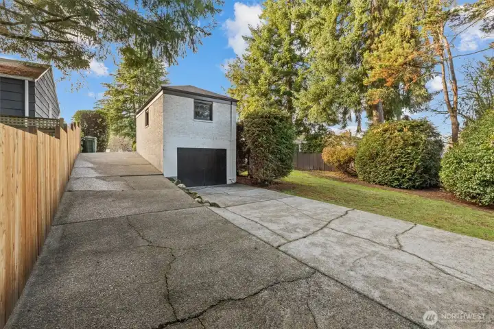Lower level garage area with ample storage and floor opening in the ceiling to double as a car workshop.