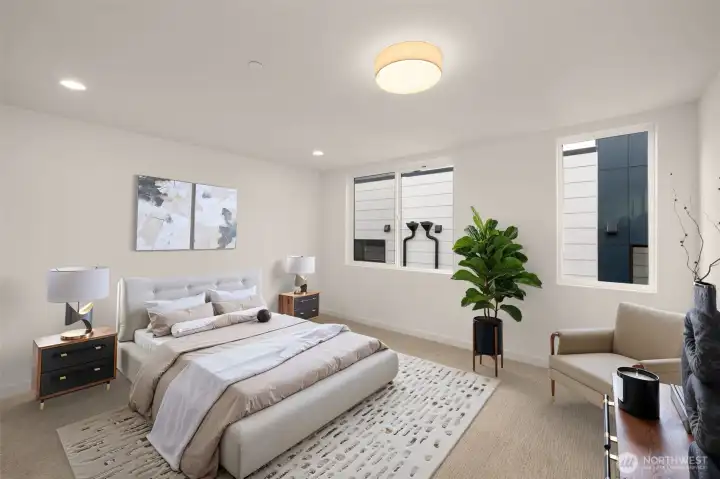 Peaceful primary suite with large windows and a clean, modern aesthetic (virtually staged)
