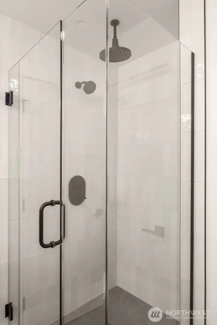 Rainfall shower surrounded by glass & floor to ceiling tile!