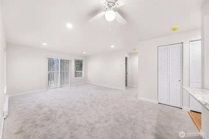 Unit #1 - Living room to slider & deck and hallway at center to 2 bedrooms