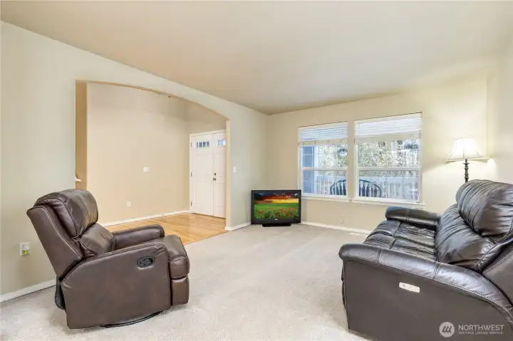 Living room with a peaceful view of the woods across the street
