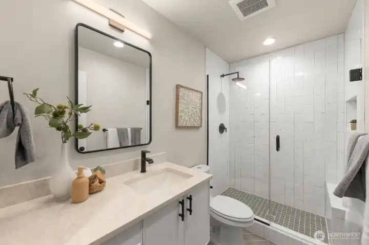 Shared bathroom with a walk-in shower, and contemporary designer tile