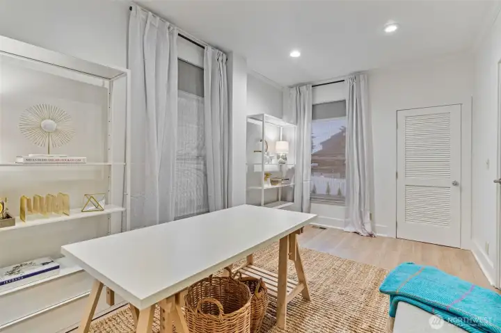 main floor office/bedroom with ample light from two large windows