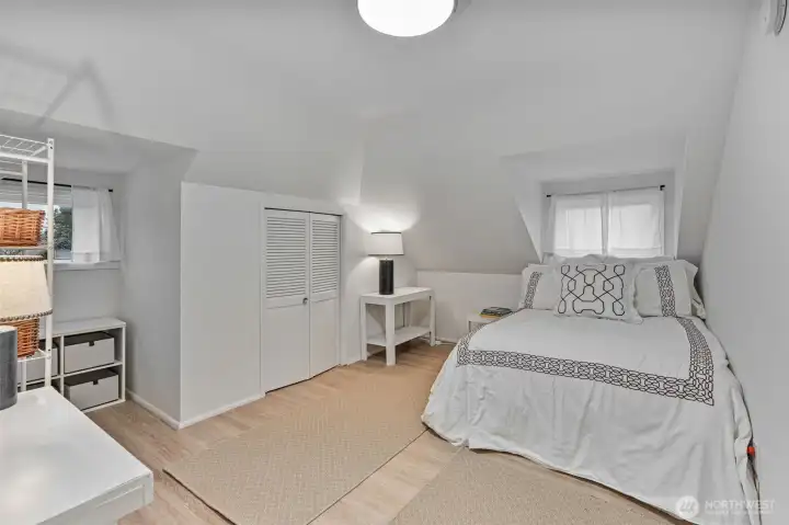 Bright, roomy bedroom that fits a queen bed with ease.