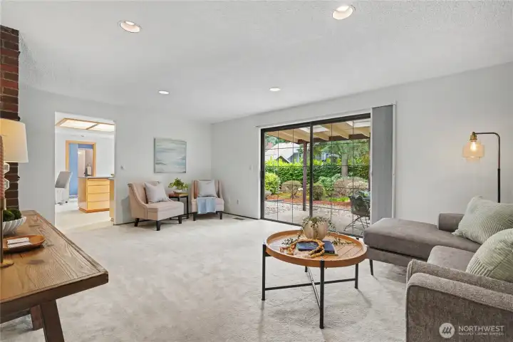 Comfortable living area with large sliding glass door providing direct access to the covered patio and backyard.