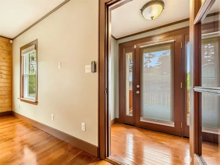 Light-filled living room with beautiful woodwork and hardwood floors