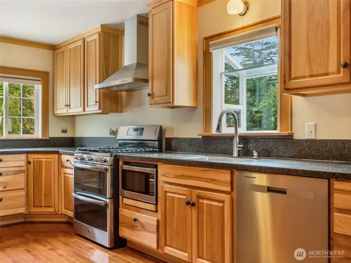 Open-concept kitchen with natural wood cabinetry and ample counter space