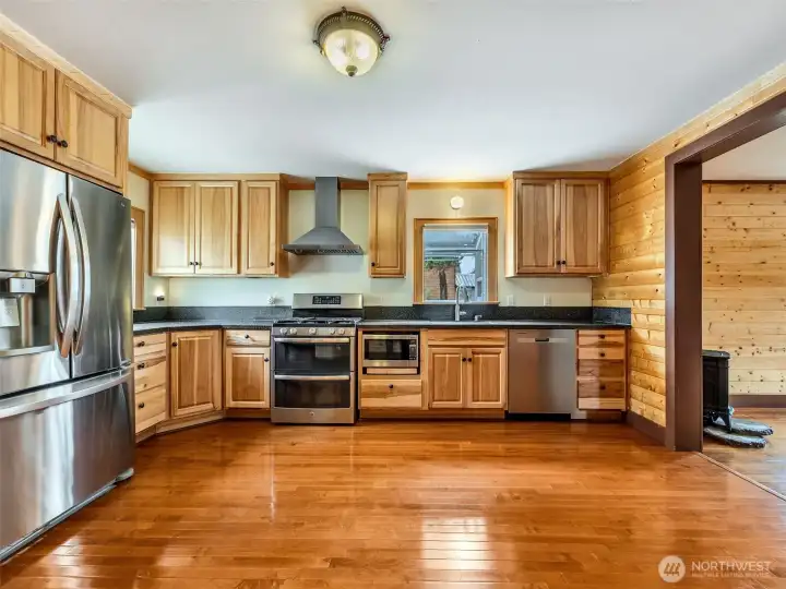 Open-concept kitchen with natural wood cabinetry and ample counter space