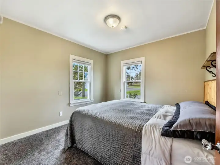 Main level bedroom with natural light and neutral tones