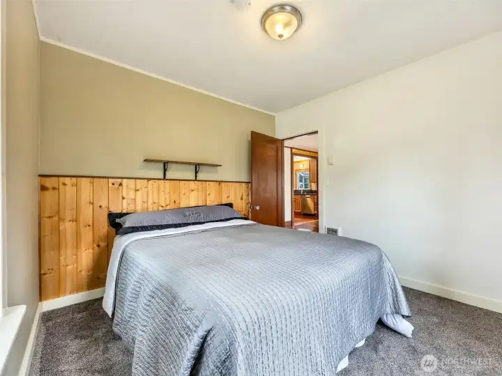 Main level bedroom with natural light and neutral tones