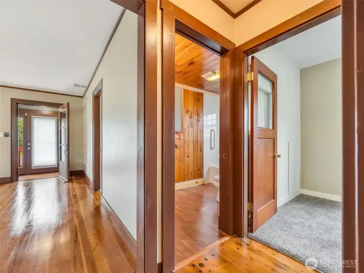hallway on the main level showing the restroom and 2nd bedroom downstairs.