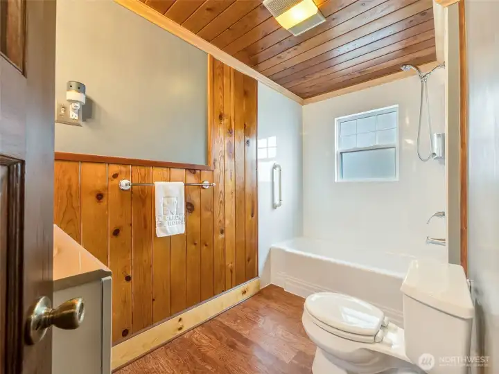 Full bathroom on the main level with functional layout and natural light.
