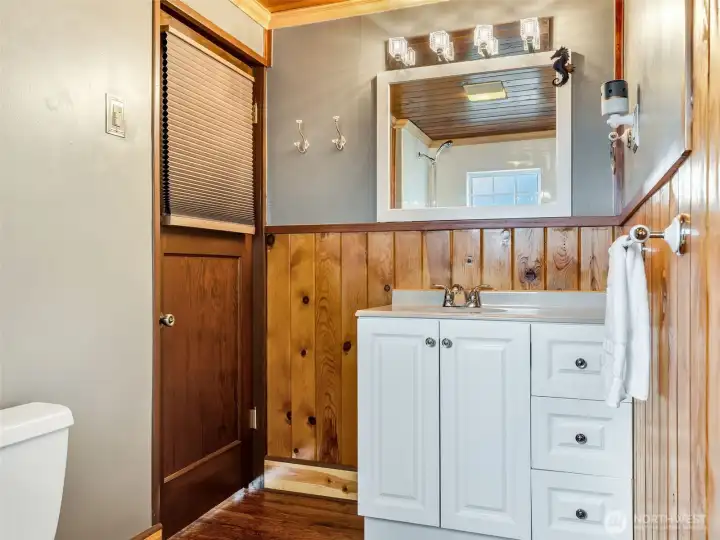 Full bathroom on the main level with functional layout and natural light.
