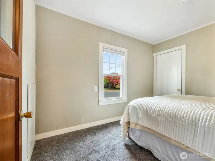 Main level bedroom with natural light and neutral tones