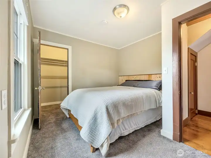 Main level bedroom with natural light and neutral tones