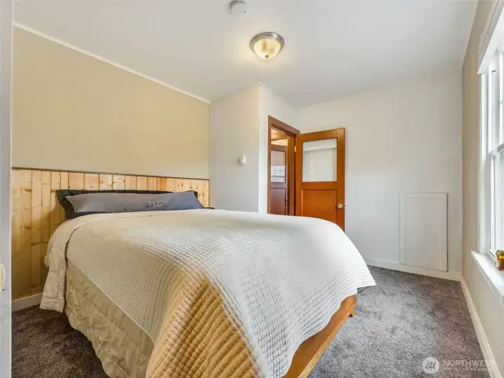 Main level bedroom with natural light and neutral tones