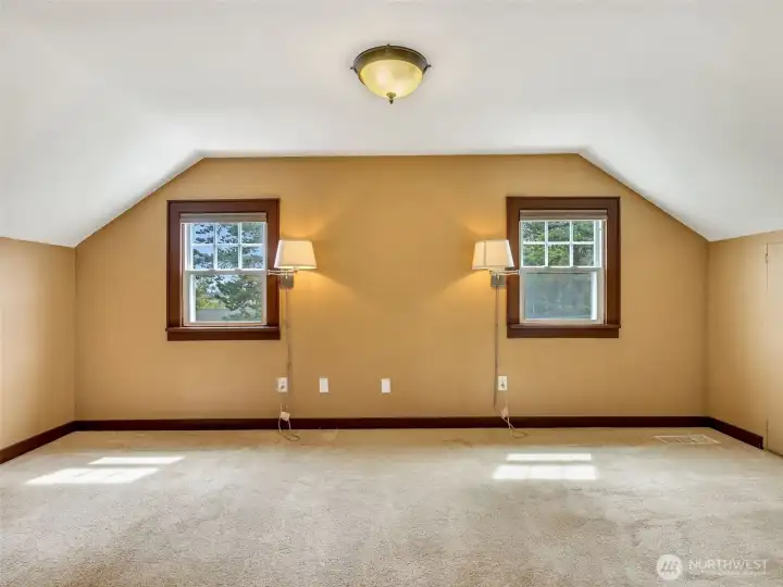 Spacious upper-level room with natural light and versatility