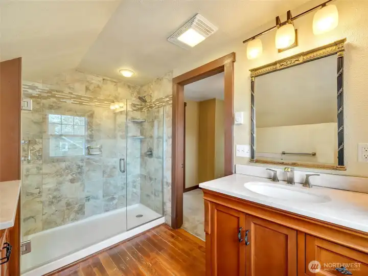 Bathroom with tiled shower and updated features and functional design