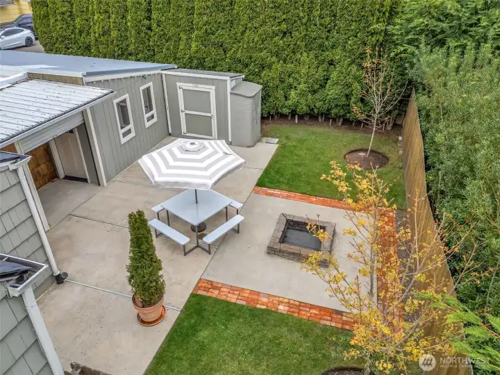 Fully fenced backyard with mature landscaping and privacy