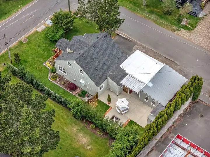 Aerial view showing home, garages, and corner lot in Seaview