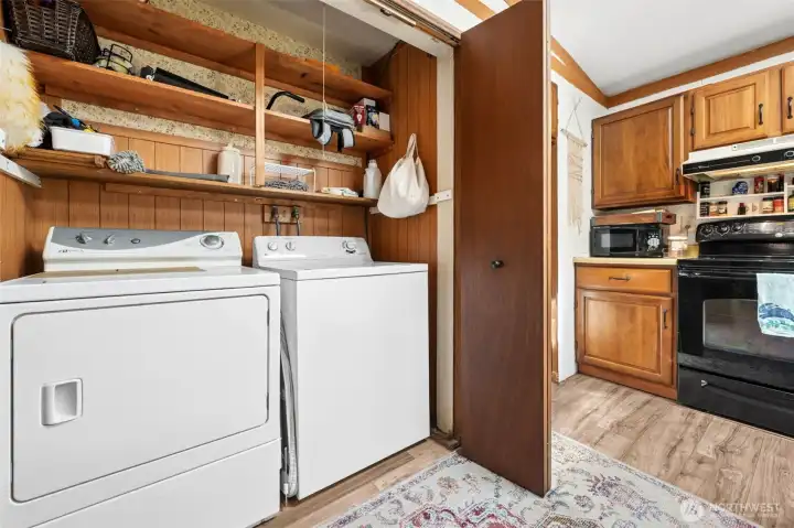 Laundry closet with shelves for storage.