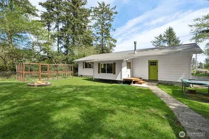 BIG backyard with fenced garden beds.