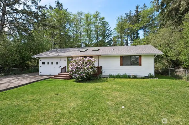 Mature trees, beautiful lawn and that stunning rhodedendron give this cutie its of curb appeal.