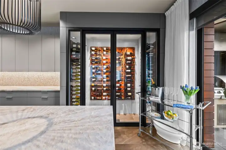 The wine refrigerator is a kitchen focal point along with creative lighting.