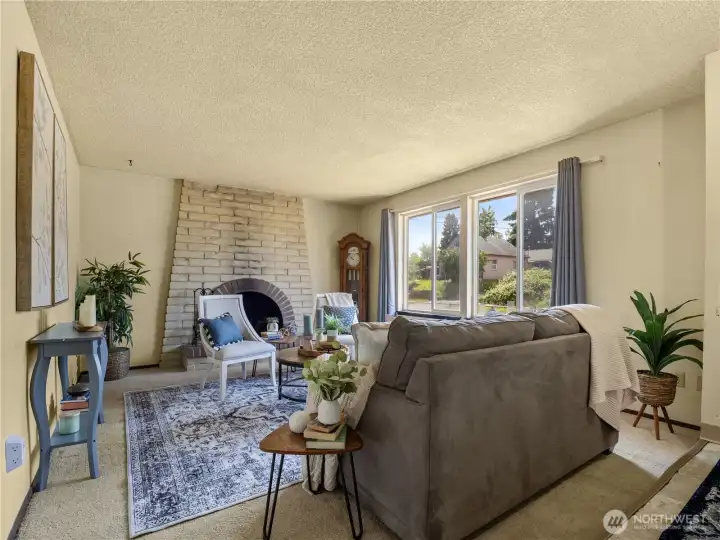 Open bright living room with a cozy fireplace. Open bright living room with a cozy fireplace.