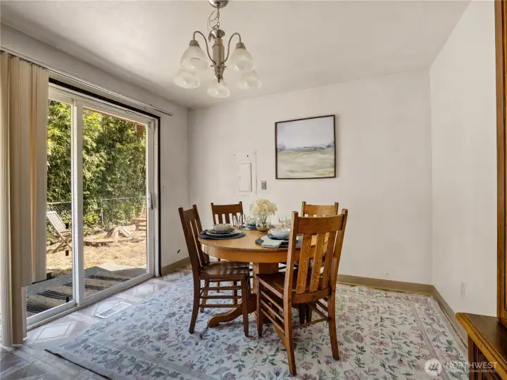 The dining area has easy access to the back yard through the sliding doors. The dining area has easy access to the back yard through the sliding doors.