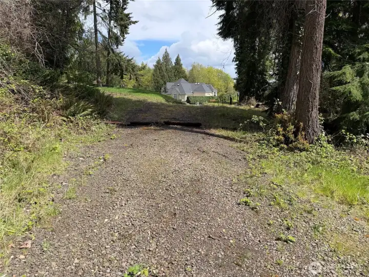Driveway into the property, the paved cul-de-sac is in the distance.