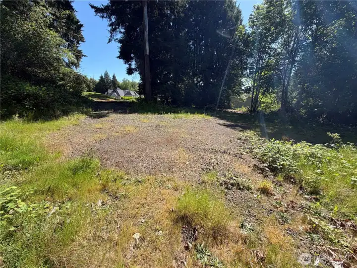 Driveway into the property, the paved cul-de-sac is in the distance.