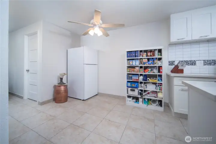Open area adjacent to kitchen offers great flex space for dining or additional storage