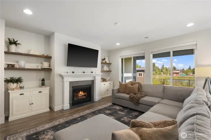 Family room with cozy gas fireplace, opening up to your private backyard