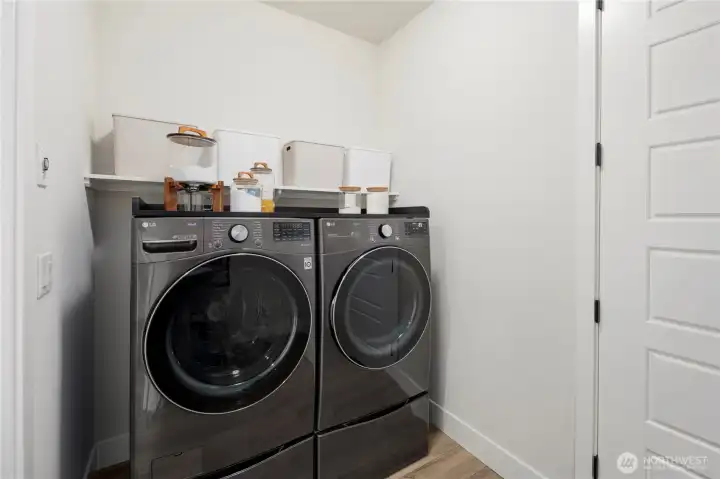 Laundry Room with plumbing rough-in for utility sink and extra storage behind the door!