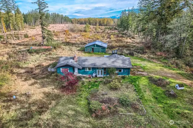 Acreage with 2400sq. ft. Rambler with Basement.  Four stall bard with fenced paddock.  Outbuildings may be savable.  Property mostly level and dry.  House is a fixer.  Main floor in good condition.  Lower level is in a complete fixer state of affairs.  Previous flood damage not repaired. Interior inspection upon proof of funds and mutual agreed contract terms.