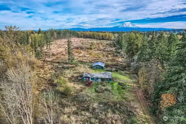 Looking from West to East. Property may have Mountain view on clear day. Treeline is a good approximate property line.  R10 zoning  Lot 435,600sq. ft. Value in the Barn and the Land.  House can be saved, serious investor only.