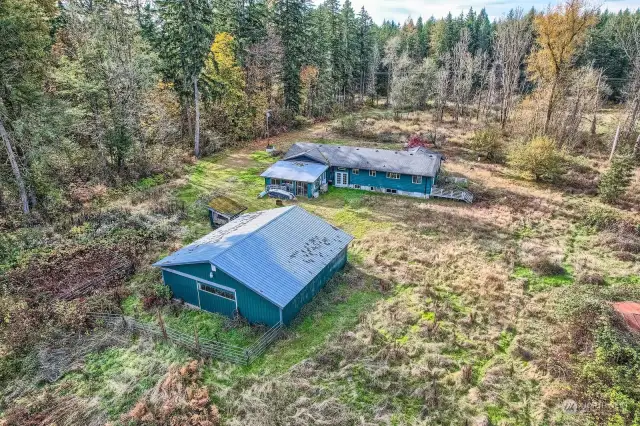 Looking from East to West.  Barn is in very good shape Dry and a lil clean up and ready to use.  Back elevation of the house shows the daylight basement.  Enclosed sun porch looks like it is still viable and needs a little tlc.